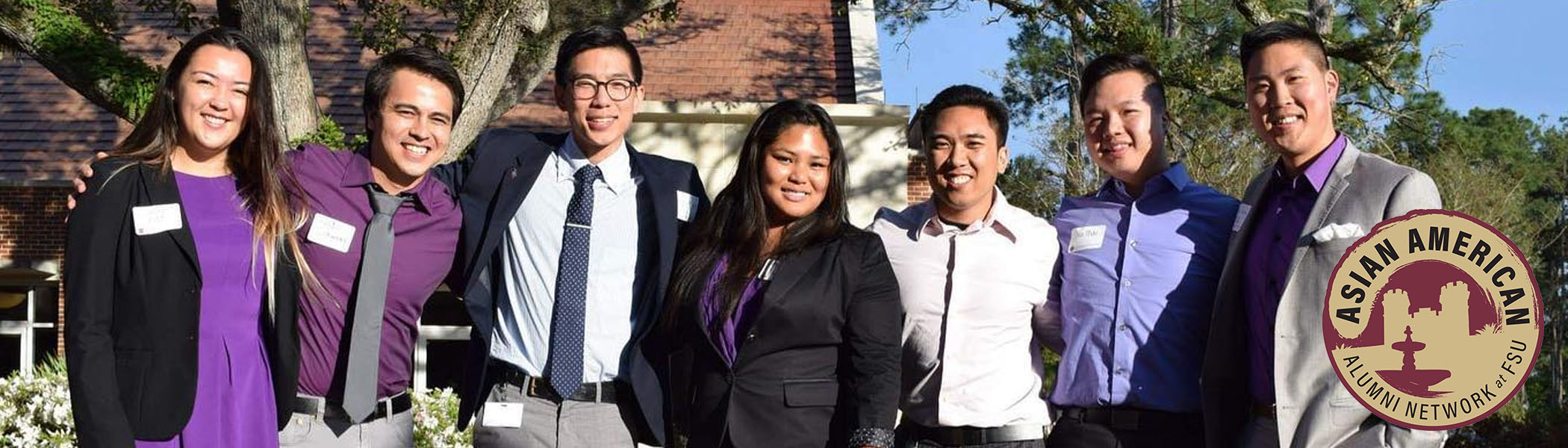 A group of Asian American students standing and smiling