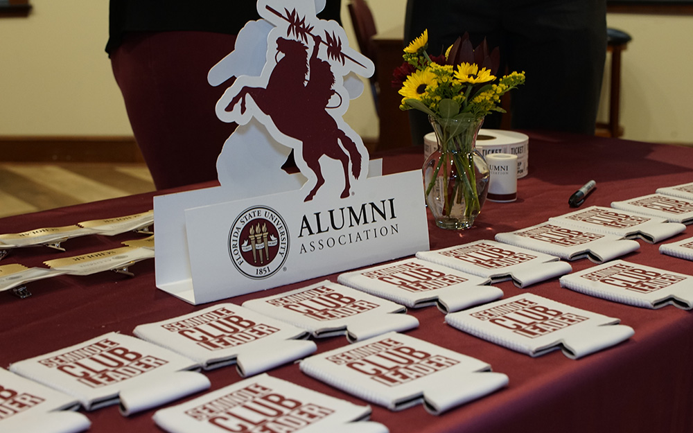 a table filled with Alumni merch