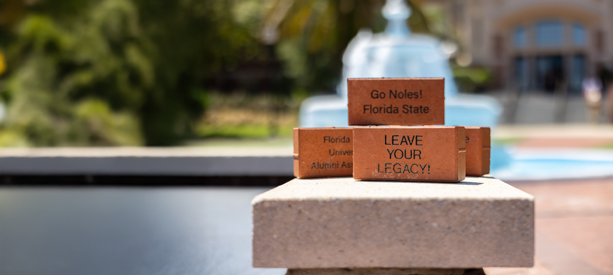 Three red bricks, the front of which says "LEAVE YOUR LEGACY!"