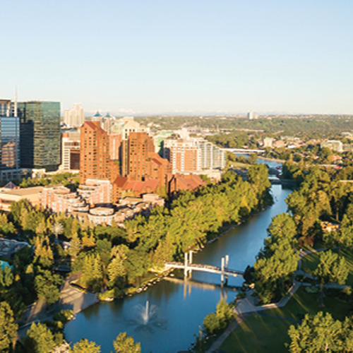 Picture of Canadian landscape with trees buildings, and a body of water