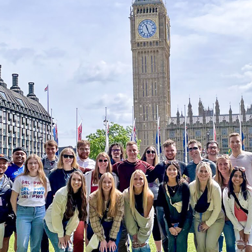 A photo of a group of young alumni in London, with Big Ben prominently in the background