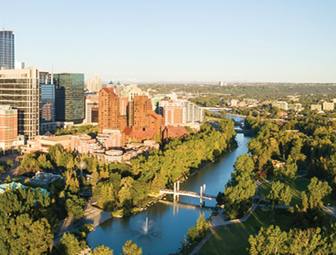 Picture of Canadian landscape with trees buildings, and a body of water